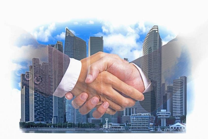 kézfogás a modern városépület pénzügyi negyedében.